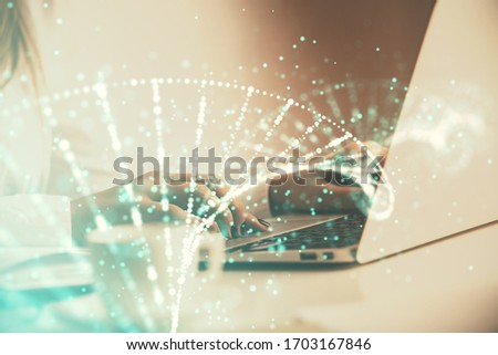 Double exposure of woman hands typing on computer and DNA hologram drawing. Medical education concept.