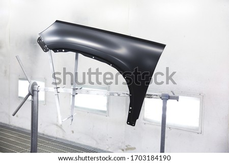 car front fender in spray booth  prepared for painting Royalty-Free Stock Photo #1703184190