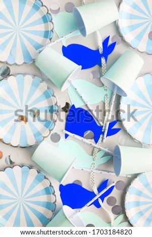 Birthday or easter party table, Background in blue and sky blue color with bunny garland. Flat lay, top view.