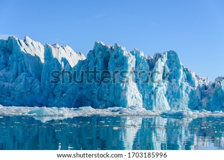 Landscape with glacier in Svalbard at summer time. Sunny weather. Royalty-Free Stock Photo #1703185996
