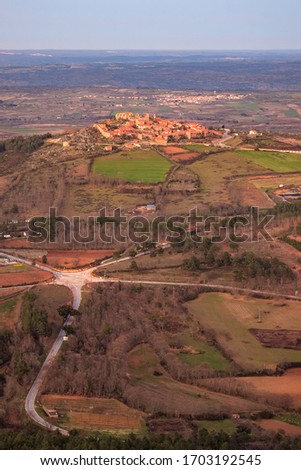 Landscape of the historic village of Castelo Rodrigo, in Portugal, seen from the top of the Serra da Marofa at the end of the day, with the road and roundabout accessing the village in the foreground.