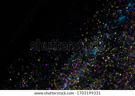 Festive twinkle glitters background, abstract blurred backdrop with circles, modern design wallpaper with sparkling glimmers. Surface with vivid colors, glittering sparkle and glow effect. Royalty-Free Stock Photo #1703199331