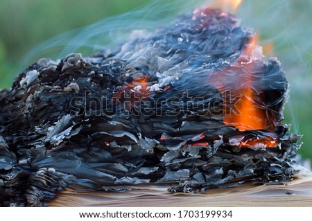 photo of a burning book in smoke