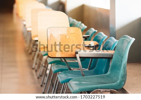 rows of school student desk and chair on the walk way for make the classroom clear - vintage photo style