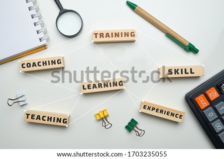 Training concept - wooden blocks with inscriptions coaching, learning, skill, teaching. Close up. Royalty-Free Stock Photo #1703235055