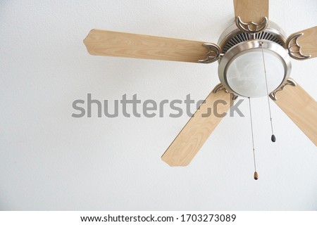 Indoor Home Ceiling Fan on a White Ceiling Royalty-Free Stock Photo #1703273089