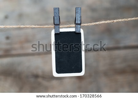 Close up of an old photo and clothes peg on a wooden background