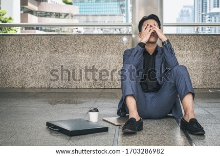 Coronavirus COVID-19 impact on businesses people lost Business project is canceled, shut down causing unemployment financial distress. Depressed crying business man Royalty-Free Stock Photo #1703286982