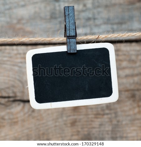 Close up of an old photo and clothes peg on a wooden background