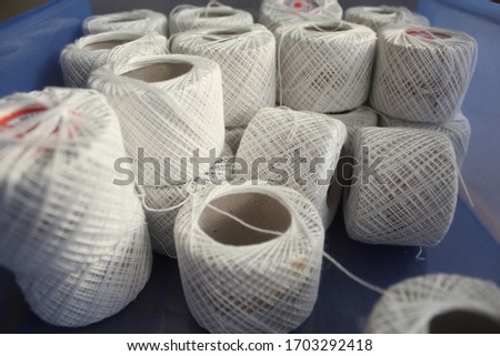 Several white ropes are stacked together.