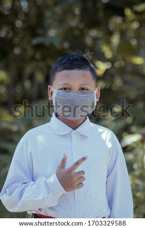 portrait of a child wearing a mask in an effort to spread the corona virus in Indonesia