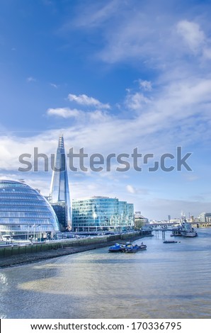 London's modern cityskape with tallest building The Shard and Town Hall on bright sky - Stock Image
