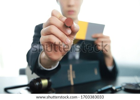 Lawyer holding stamp with law book. 