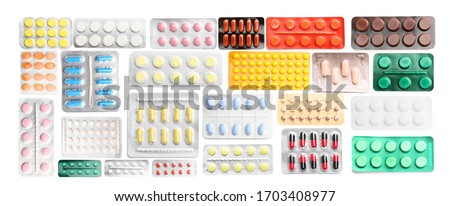 Many different blisters with pills on white background Royalty-Free Stock Photo #1703408977