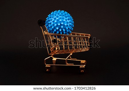 Blue virus molecule on a shopping cart conceptual of the possibility of infection with corona virus or Covid-19 over a black background