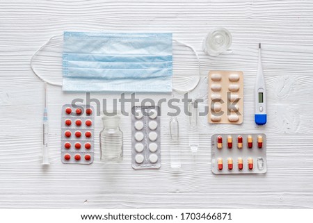 Cold, flu and virus treatment - flat lay with medicine - on white wooden background top view