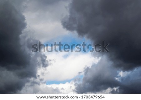 stormy grey and white clouds on blue sky background