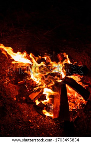Closeup picture of a campfire at night outdoors.