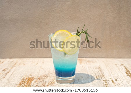 Blue Lemon Soda drink on outdoor wooden table in sunny day