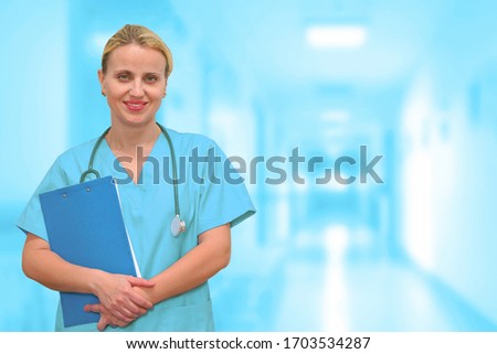 Doctor or surgeon with a folder on the background of a blurred corridor of the clinic. Medical web sites with copy space. Health care banner.