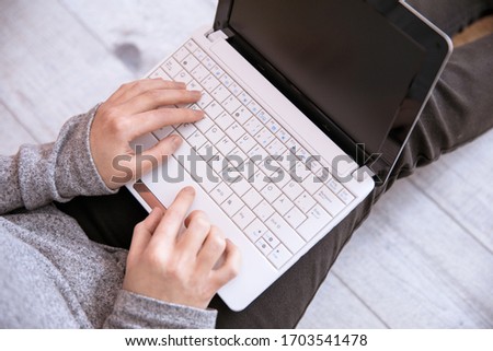 woman working in computer sitting in ground
