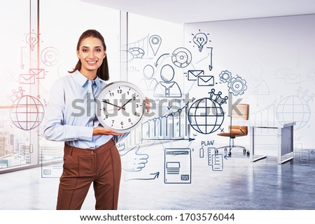 Cheerful young businesswoman holding clock in sunlit CEO office with double exposure of creative business plan sketch. Toned image