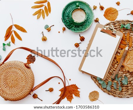 Trendy flat lay composition with coffee cup and autumn leaf, Office table with clip board, blogger concept