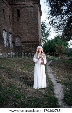 girl in a white dress near the old castle