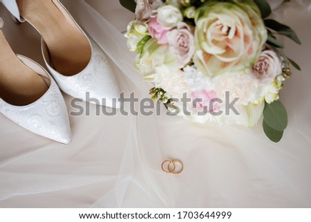 wedding dress on a hanger in a room at home