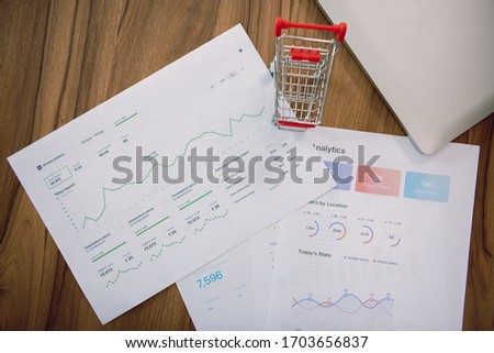 Financial reports. Graphs and charts. Documents on wood table