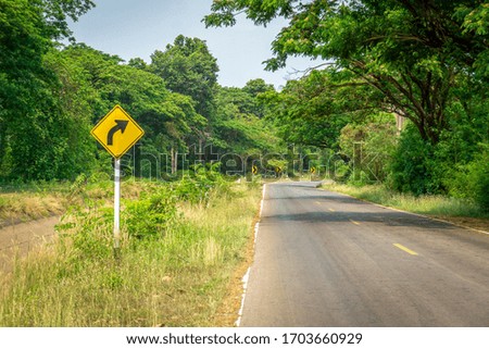 Curved warning signs with a natural background
