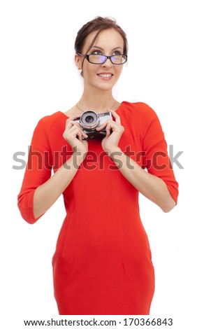 Girl in a red dress with shiny camera on a white background