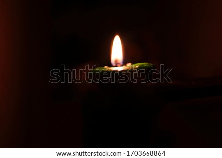 A Diya glowing at night