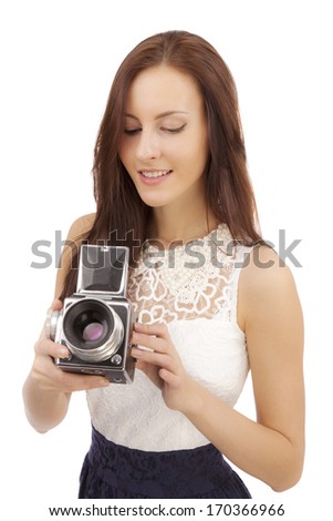 Girl with an old camera on a white background