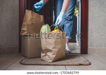 Coronavirus. Quarantine, contactless delivery during a pandemic covid. Stay at home, Online shopping. Food boxes and stamp. Contactless delivery. Royalty-Free Stock Photo #1703682799