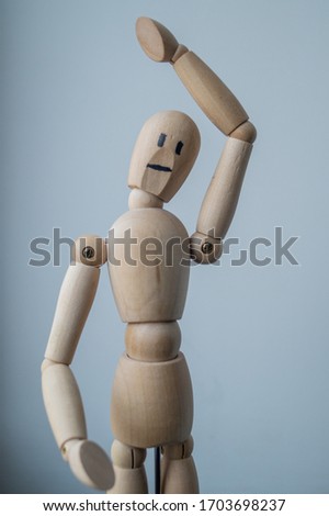 interior element a wooden doll in the shape of a man on hinges close up at home shooting point at eye level
