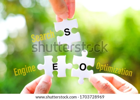 The SEO (Search Engine Optimization) word on white jigsaw puzzle go to replace homepage word on green gap - idea answer concept.