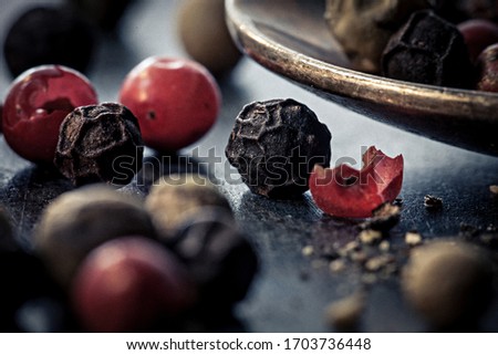 closeup picture of pepper in red and black on a dark table