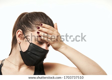 Worried, scare, panicked american woman in medical mask, concerned about viral pandemic illness, paranoid of pandemic. Royalty-Free Stock Photo #1703737510