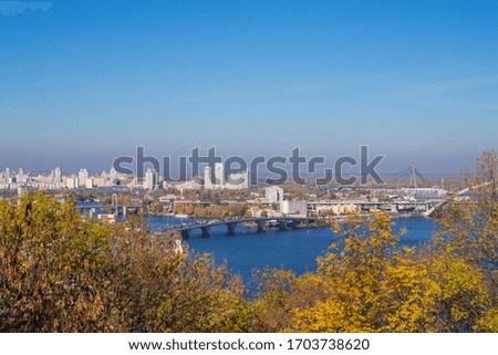 Autumn city landscape, panorama. Top view of the Dnieper River and the left bank of Kyiv - the capital of Ukraine. The concept of natural beauty. Kyiv (Kiev), Ukraine, Europe.
