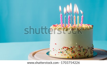 White Birthday cake on blue sky background.food concept anniversary background.