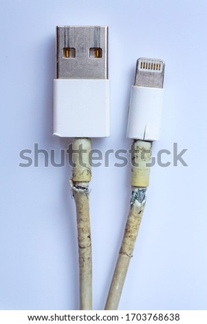 Damaged white usb cable plug and micro usb plug or Old Smart Phone Charger Cable broken on white acrylic background, Close up & Macro shot, Select focus, Technology, Business concept