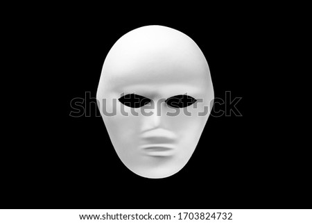 White human face mask isolated on black background
