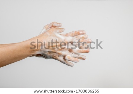 Close up of Caucasian woman washing her hands isolated on white background. Demonstration of hand washing. Concept of hygiene and prevention coronavirus.