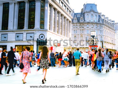 Motion blurred crowds of shoppers on busy London street Royalty-Free Stock Photo #1703866399