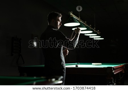 A snooker player is scraping the cue