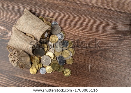 sack bag with Malaysia Ringgit coin on wooden table.- Saving Concept