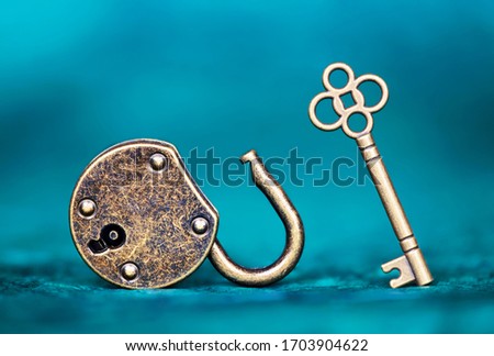 Success, solution, life coaching mentor concept. Key and unlocked padlock on blue background.