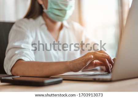 Woman work from home wearing mask protection wait for epidemic situation to improve soon at home. Coronavirus, covid-19, Work from home (WFH), Social distancing, Quarantine, Prevent infection concept. Royalty-Free Stock Photo #1703913073