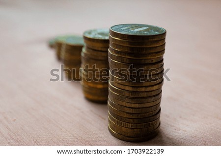 Piles of coins decreasing in crisis